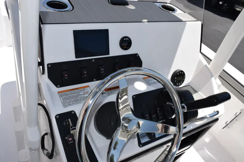 Slide: The Image of 2026 Yamaha Boats 190 FSH Sport dashboard with steering wheel and control panel. - 10