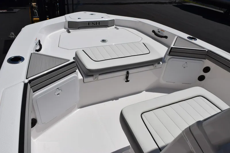 Slide: The Image of 2026 Yamaha Boats 190 FSH Sport interior with cushioned seating and storage compartments. - 11