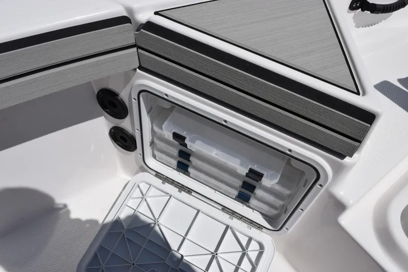 Slide: The Image of Storage compartment on 2026 Yamaha Boats 190 FSH Sport, featuring organized tackle boxes. - 16