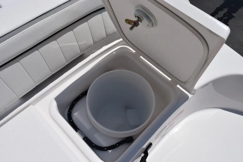 Slide: The Image of Open storage compartment on 2026 Yamaha Boats 190 FSH Sport, featuring a built-in bucket. - 21