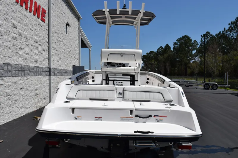 Slide: The Image of 2026 Yamaha Boats 190 FSH Sport, rear view, parked outdoors near a building. - 5
