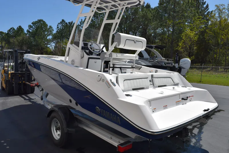 Slide: The Image of 2026 Yamaha Boats 190 FSH Sport, sleek design, parked outdoors on a trailer. - 6