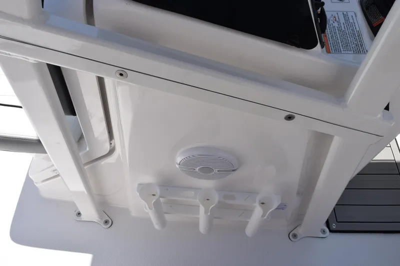 Slide: The Image of 2026 Yamaha Boats 190 FSH Sport interior detail with rod holders and speaker. - 8