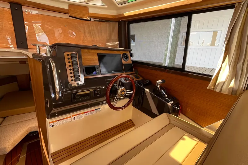 Slide: The Image of Interior of 2025 Ranger Tugs R-27 Seakeeper Ride, featuring modern helm and controls. - 22