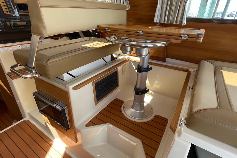 Slide: The Image of Interior of 2025 Ranger Tugs R-27 Seakeeper Ride with seating and wooden accents. - 27