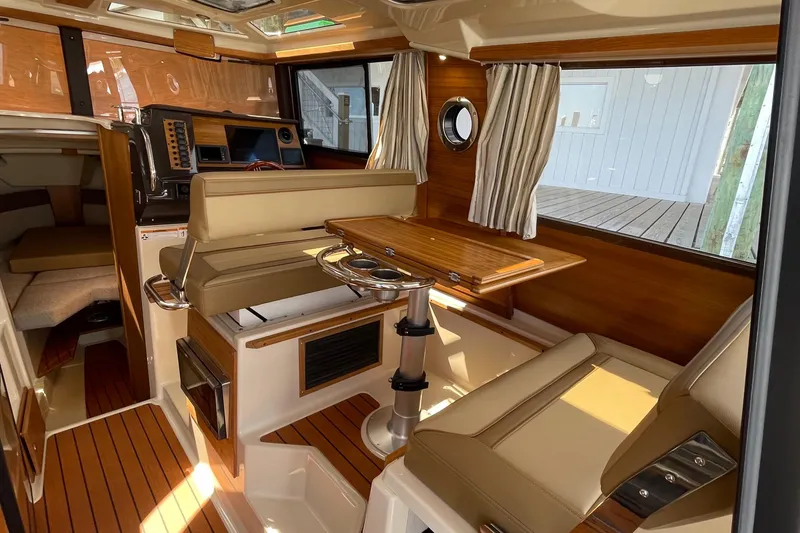 Slide: The Image of Interior of 2025 Ranger Tugs R-27 Seakeeper Ride, featuring elegant wood finishes and seating. - 28