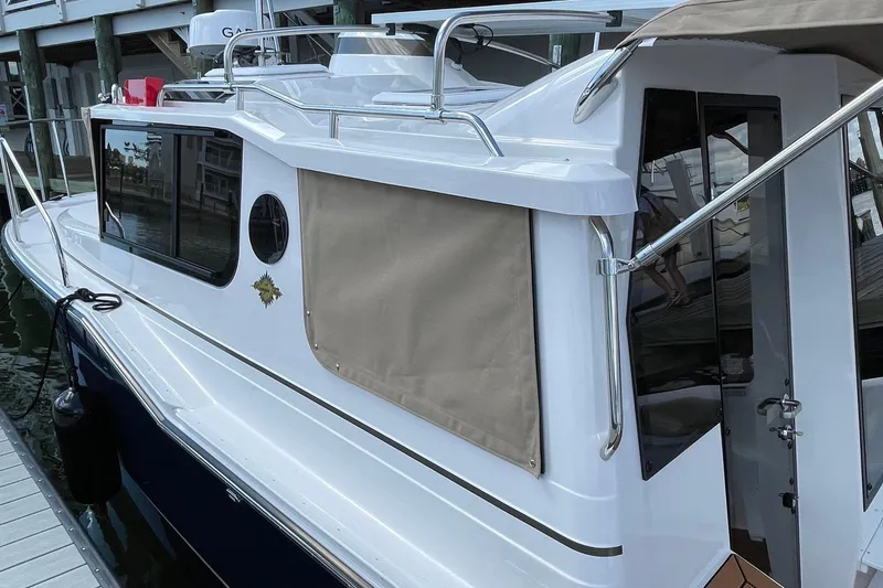 Slide: The Image of 2025 Ranger Tugs R-27 Seakeeper Ride docked, showcasing sleek design and modern features. - 3