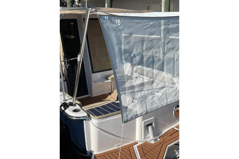 Slide: The Image of 2025 Ranger Tugs R-27 Seakeeper Ride with deck canopy and seating area. - 5