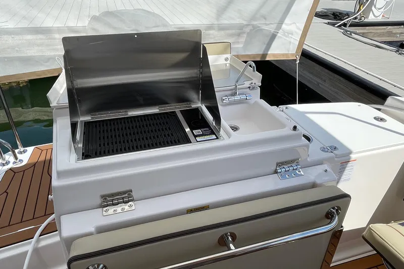 Slide: The Image of Outdoor grill and sink on 2025 Ranger Tugs R-27 Seakeeper Ride boat deck. - 7