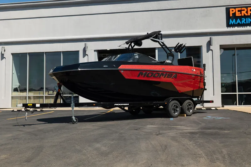The Image of 2025 Moomba Max boat on trailer outside dealership. - 1