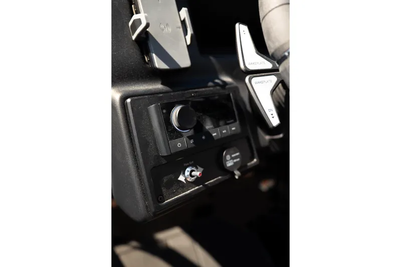 Slide: The Image of 2025 Moomba Max dashboard controls with wakeplate adjustment and phone holder. - 11