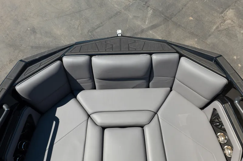Slide: The Image of 2025 Moomba Max boat interior with gray cushioned seating and cup holders. - 12