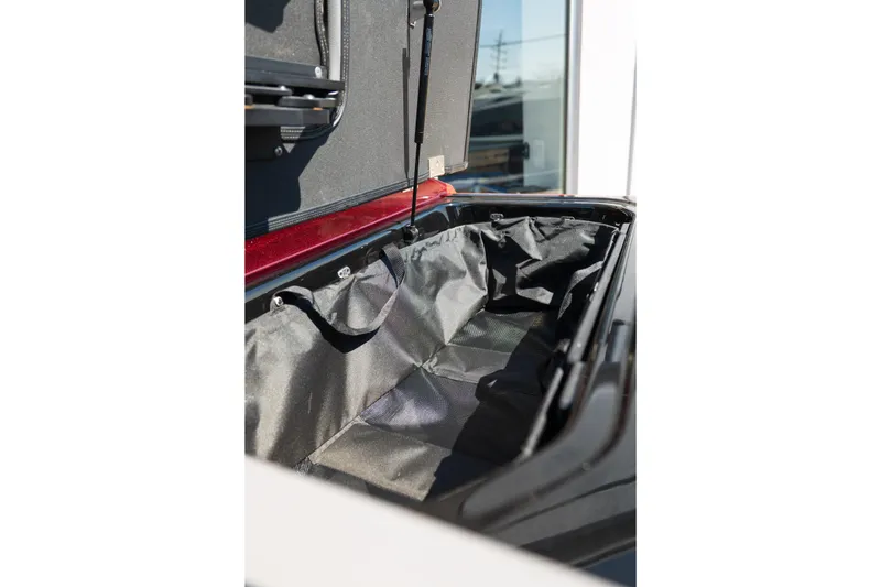 Slide: The Image of Open storage compartment of 2025 Moomba Max boat, showcasing interior space and design. - 14