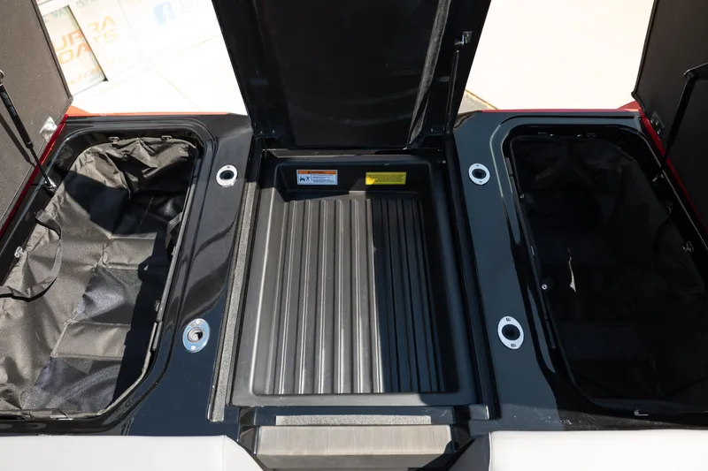 Slide: The Image of 2025 Moomba Max boat storage compartments with open lids, showcasing spacious interior design. - 16