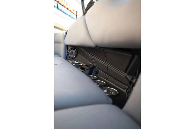 Slide: The Image of Interior of 2025 Moomba Max boat featuring cup holders and speaker system. - 18
