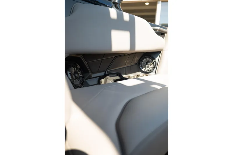 Slide: The Image of 2025 Moomba Max interior with speakers and cup holders in sunlight. - 19