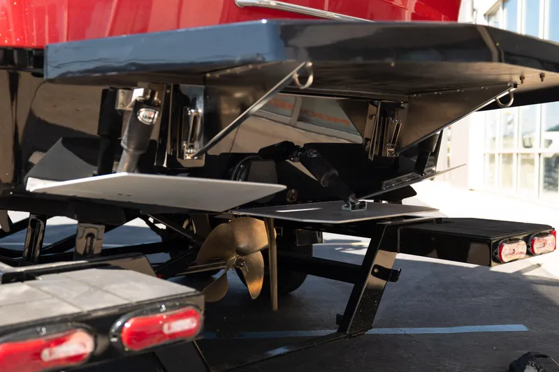 Slide: The Image of 2025 Moomba Max boat stern with propeller and trim tabs in a showroom. - 6
