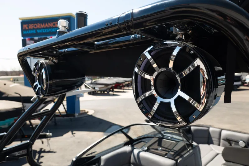 Slide: The Image of 2025 Moomba Max boat with sleek speakers and modern design at a marine dealership. - 9