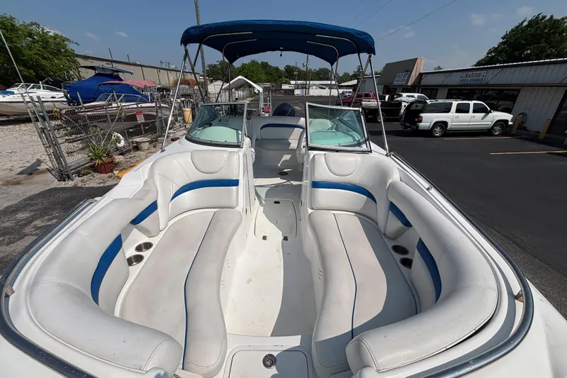 Slide: The Image of 2013 Hurricane SunDeck 2200 DC OB boat with spacious seating and blue canopy. - 11