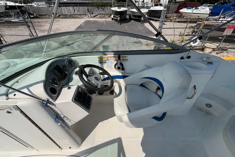 Slide: The Image of 2013 Hurricane SunDeck 2200 DC OB boat cockpit with steering wheel and control panel. - 13