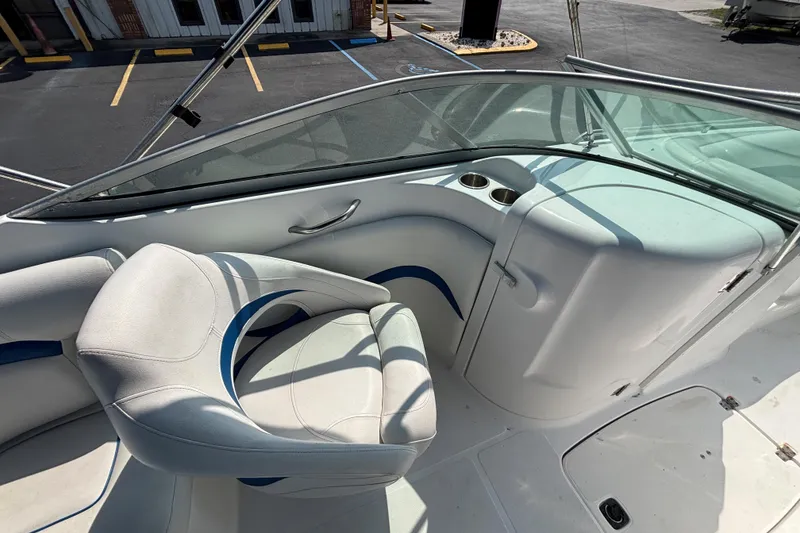 Slide: The Image of 2013 Hurricane SunDeck 2200 DC OB boat interior with white seating and cup holders. - 14