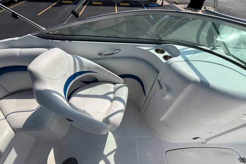 Slide: The Image of 2013 Hurricane SunDeck 2200 DC OB boat interior with white seating and cup holders. - 18