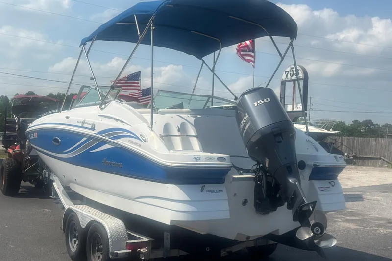 Slide: The Image of 2013 Hurricane SunDeck 2200 DC OB boat with Yamaha 150 engine on trailer. - 2