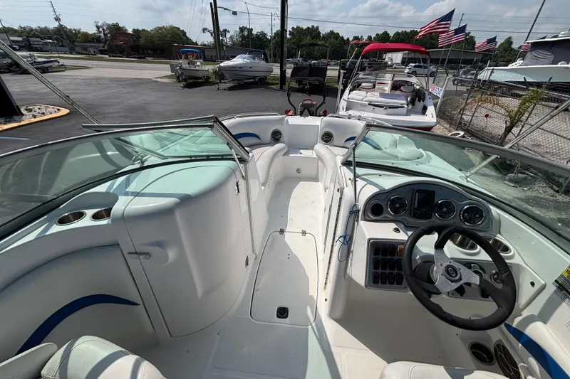Slide: The Image of 2013 Hurricane SunDeck 2200 DC OB boat interior with steering wheel and seating area. - 21