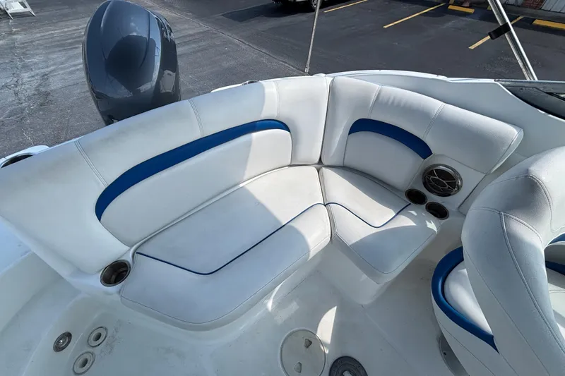 Slide: The Image of 2013 Hurricane SunDeck 2200 DC OB boat seating area with white and blue upholstery. - 23