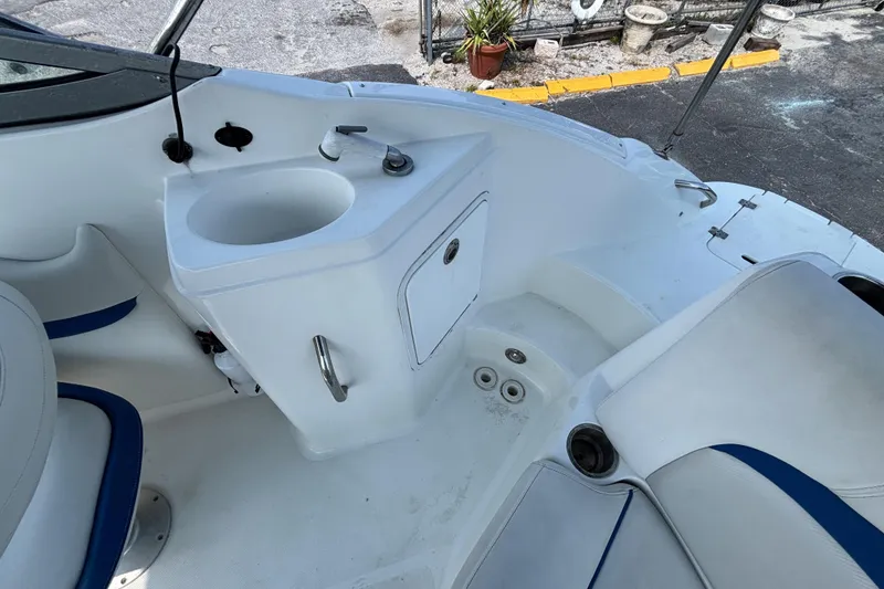Slide: The Image of 2013 Hurricane SunDeck 2200 DC OB boat interior with sink and seating area. - 24