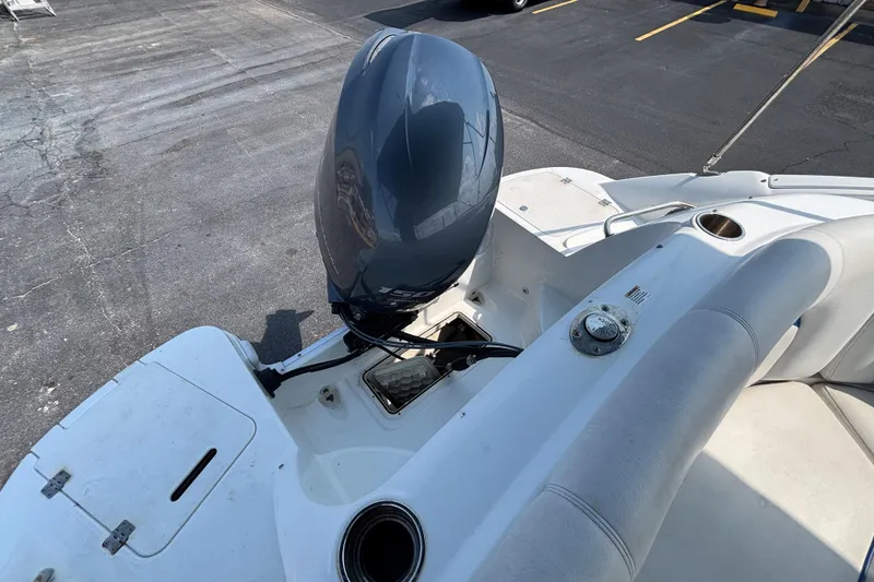 Slide: The Image of 2013 Hurricane SunDeck 2200 DC OB boat with outboard motor, docked on pavement. - 26