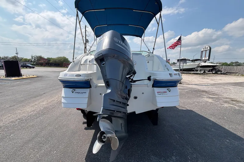 Slide: The Image of 2013 Hurricane SunDeck 2200 DC OB boat with Yamaha outboard motor, parked outdoors. - 27