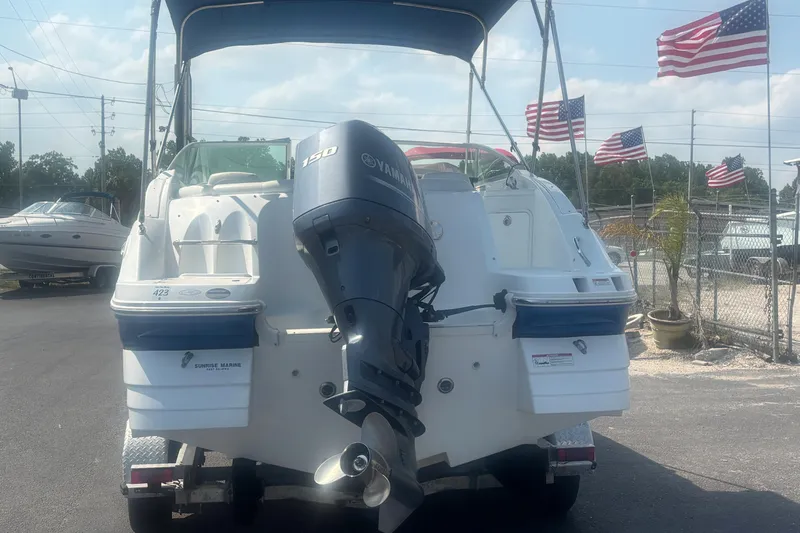 Slide: The Image of 2013 Hurricane SunDeck 2200 DC OB boat with Yamaha 150 engine, displayed outdoors. - 3