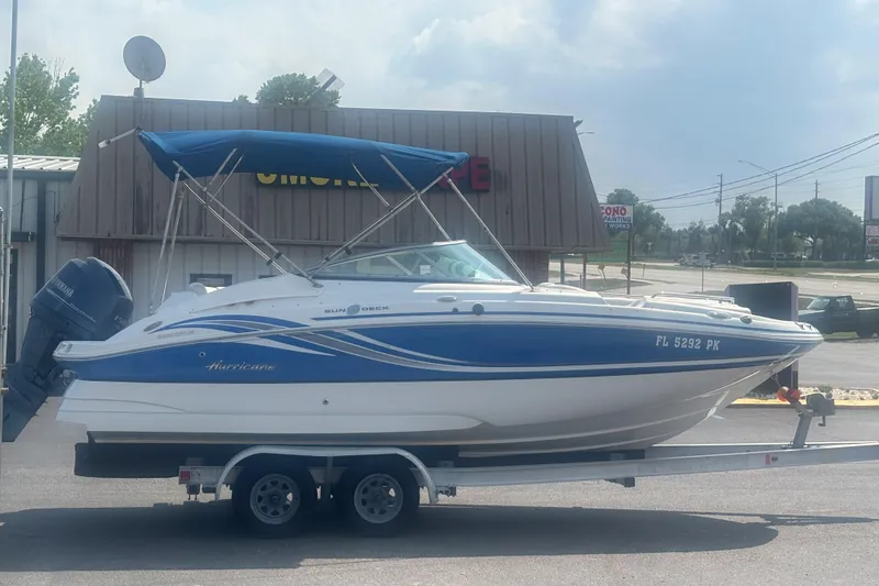 Slide: The Image of 2013 Hurricane SunDeck 2200 DC OB boat on trailer, blue and white design. - 5