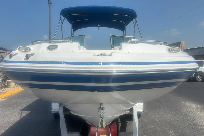 Slide: The Image of 2013 Hurricane SunDeck 2200 DC OB boat with blue canopy on trailer. - 8