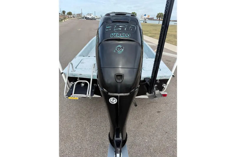 Slide: The Image of 2018 Haynie 25' Magnum boat with a 350 Verado engine, parked on a coastal road. - 12