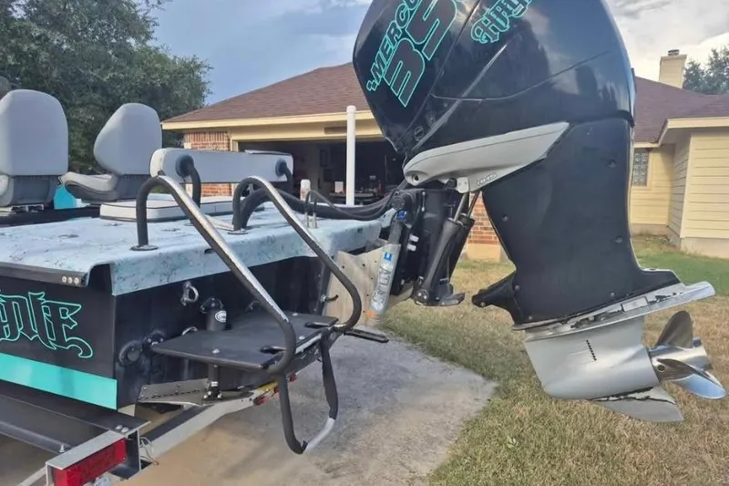 Slide: The Image of 2018 Haynie 25' Magnum boat with Mercury engine, parked in driveway. - 15