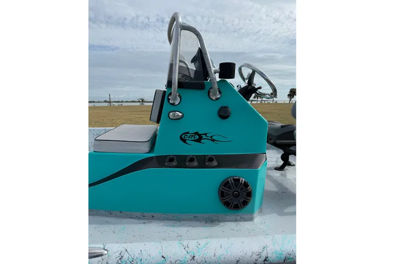 Slide: The Image of 2018 Haynie 25' Magnum boat console with teal design and steering wheel. - 17