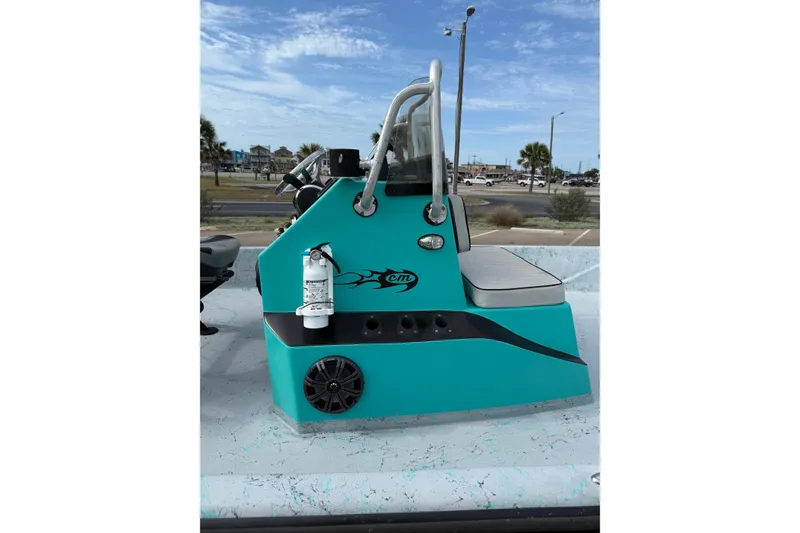 Slide: The Image of 2018 Haynie 25' Magnum boat console with teal design and fire extinguisher. - 18