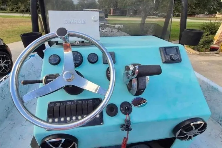 Slide: The Image of 2018 Haynie 25' Magnum boat dashboard with steering wheel and control panel. - 8