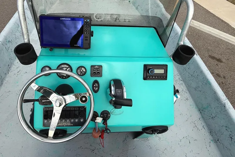 Slide: The Image of 2018 Haynie 25' Magnum boat dashboard with steering wheel and navigation system. - 9