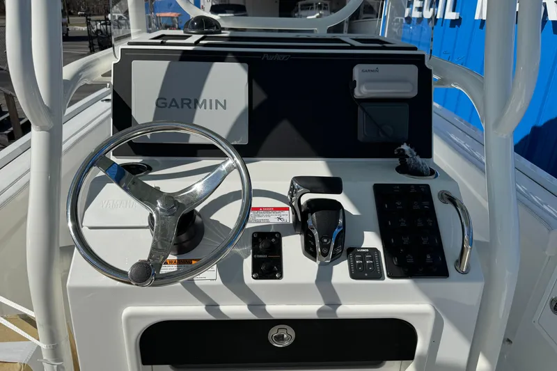 Slide: The Image of 2026 Parker 230 Coastal Elite boat dashboard with Garmin navigation system and steering wheel. - 5