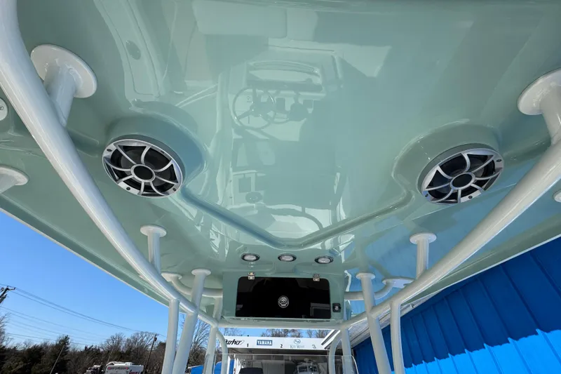 Slide: The Image of 2026 Parker 230 Coastal Elite boat ceiling with speakers and support poles. - 6