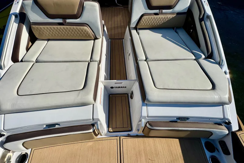 Slide: The Image of 2022 Yamaha Boats 275SD interior with luxurious seating and teak flooring. - 13