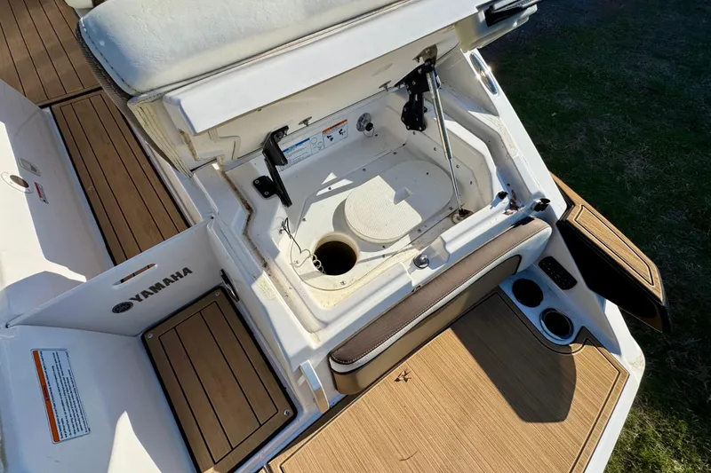 Slide: The Image of 2022 Yamaha Boats 275SD storage compartment with open hatch, showcasing interior details and deck design. - 14