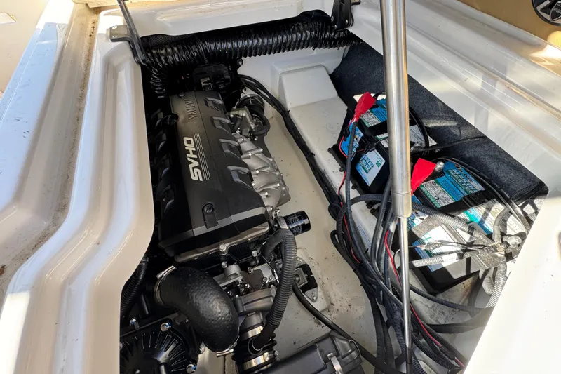 Slide: The Image of Engine compartment of 2022 Yamaha Boats 275SD with visible batteries and wiring. - 20