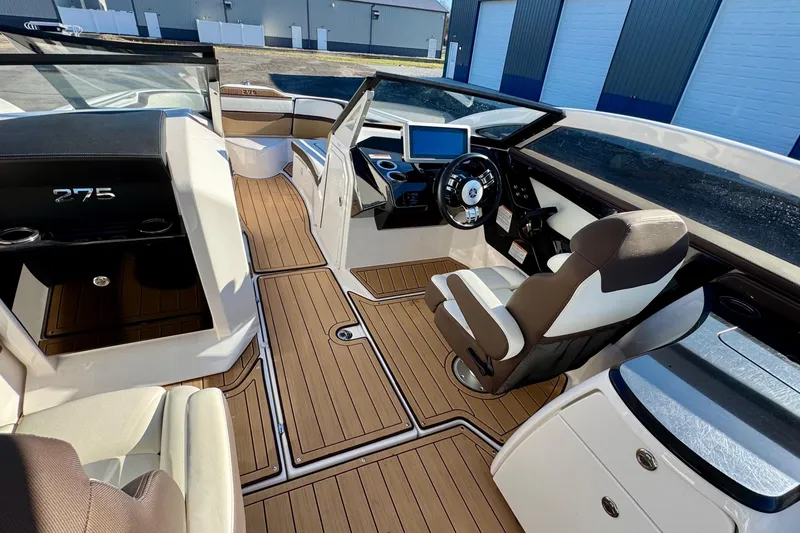 Slide: The Image of 2022 Yamaha Boats 275SD interior with modern helm, luxurious seating, and sleek design. - 25