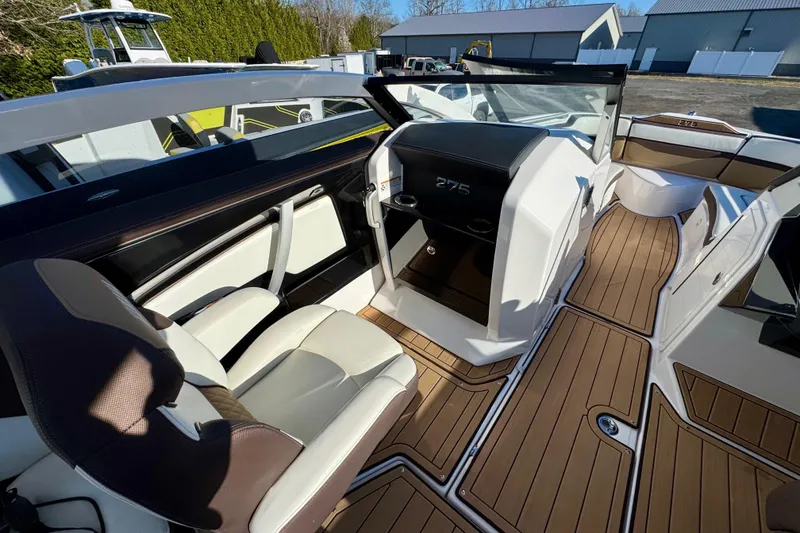 Slide: The Image of 2022 Yamaha Boats 275SD interior with sleek seating and modern dashboard design. - 26