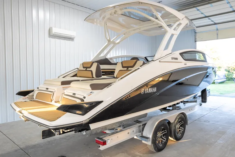 Slide: The Image of 2022 Yamaha Boats 275SD in a garage, showcasing sleek design and luxury features. - 3