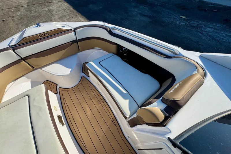 Slide: The Image of 2022 Yamaha Boats 275SD interior with luxurious seating and teak-style flooring. - 31